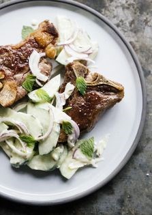 Shaved onion salad with cucumber, yogurt, and mint over lamb chops