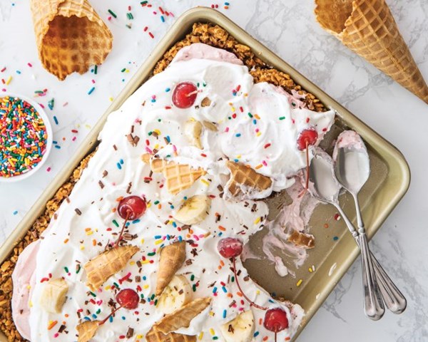 Sheet pan banana split [waffle cone crust; chocolate ganache; sweetened whipped cream]