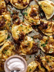 Sheet pan pierogies with caramelized onions and chipotle sour cream