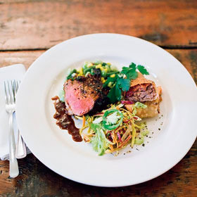 Shellacked Hoosier pork tenderloin with pulled pork spring rolls, Midwestern corn succotash & farm slaw