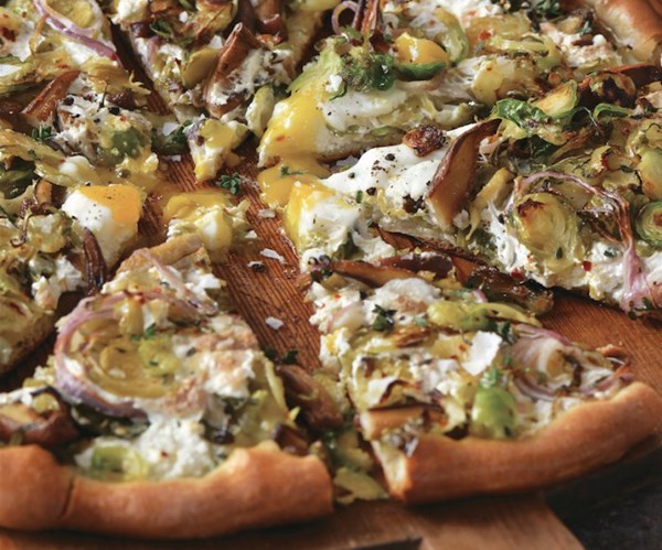 Shiitake "bacon" and shredded Brussels sprouts pizza with an egg on top