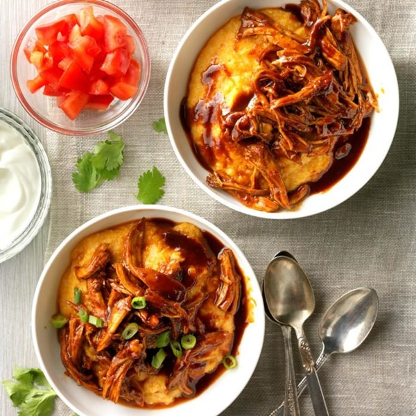 Shredded barbecue chicken over grits