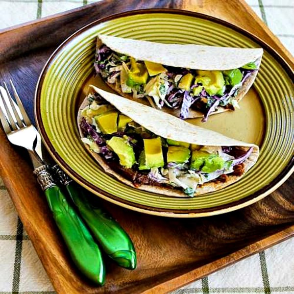 Shredded beef tacos with spicy slaw and avocado