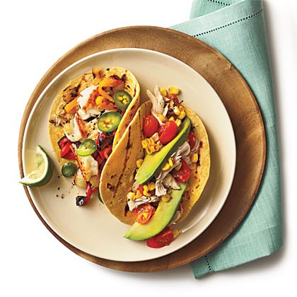 Shredded chicken tacos with tomatoes and grilled corn
