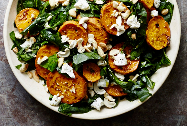 Shredded collard green salad with roasted sweet potatoes and cashews