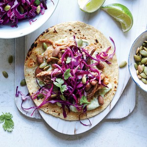 Shredded pork and pinto tacos with pepita slaw