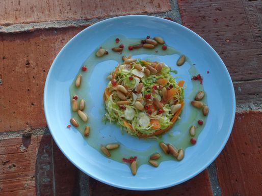 Shredded raw Brussels sprouts salad with red peppercorns and honey mustard vinaigrette