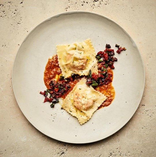 Shrimp and salt cod ravioli with yellow pepper romesco sauce