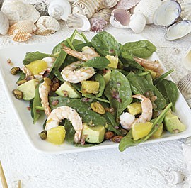 Shrimp and spinach salad with orange, avocado, and pistachios