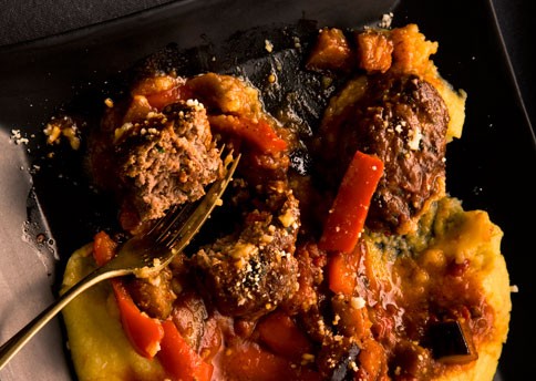 Sicilian lamb patties braised with eggplant, peppers, and tomatoes