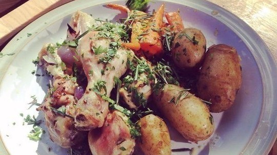 Simple roast chicken pieces with forty cloves of garlic, rosemary and thyme