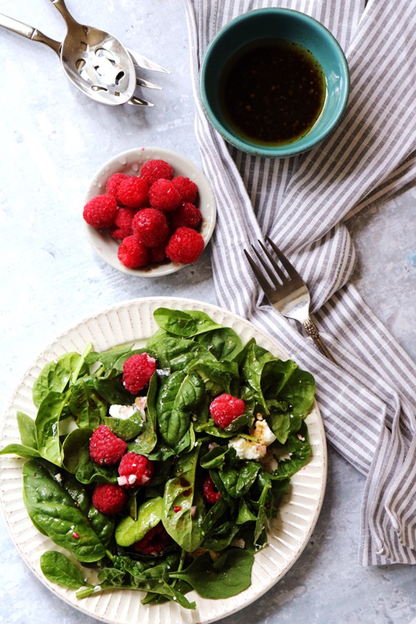 Simple spinach salad with raspberries, goat cheese, and balsamic vinaigrette