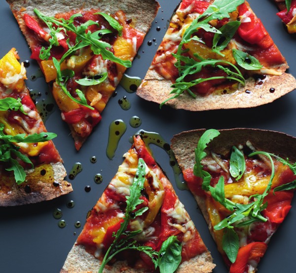 Simple tortilla pizza bites with tomatoes, pecorino cheese and rocket