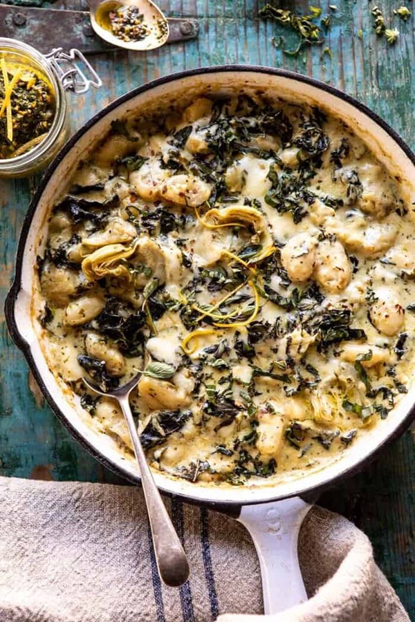Skillet baked creamy pesto spinach and artichoke gnocchi