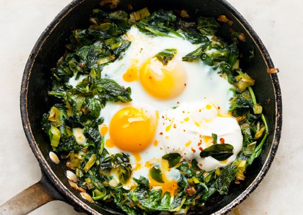 Skillet-baked eggs with spinach, yogurt, and chili oil