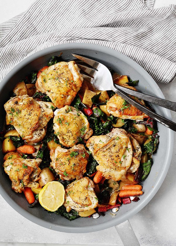 Skillet chicken thighs with potatoes, carrots, and greens recipe | Eat ...