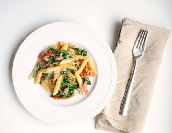 Skillet penne with sausage, sun-dried tomatoes, and spinach