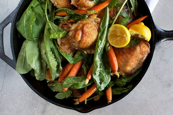 Skillet roasted chicken thighs with dandelion greens + baby carrots