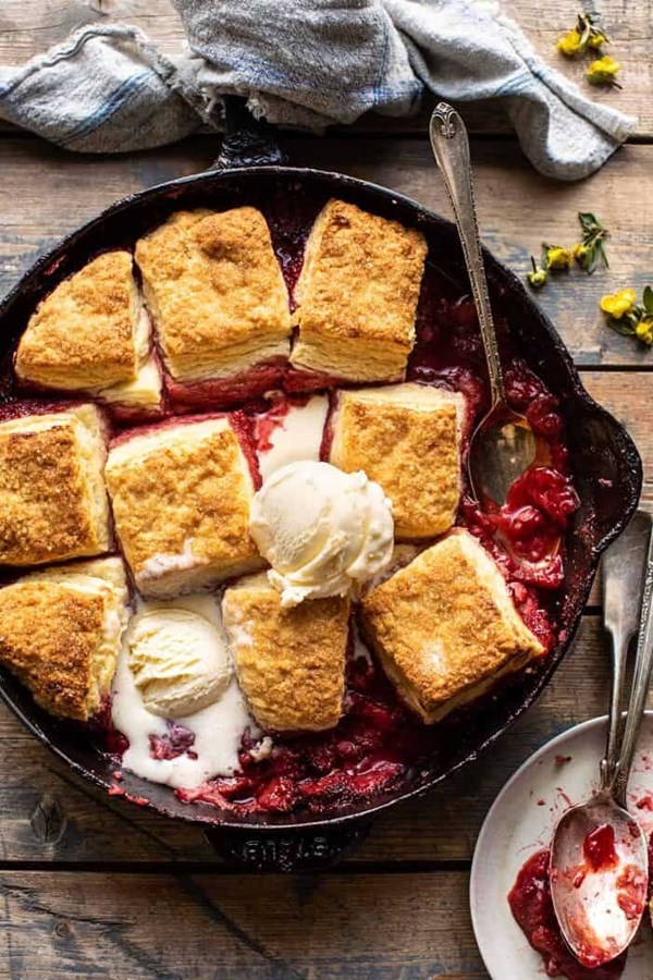 Skillet strawberry bourbon cobbler with layered cream cheese biscuits