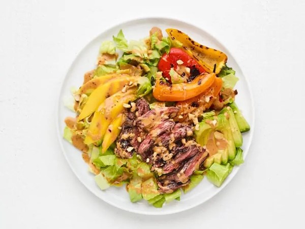 Skirt steak salad with spicy peanut dressing 