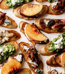 Sliced gochujang pork chops with peaches and goat cheese crostini