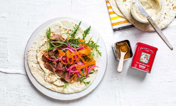 Sliced lamb steaks with rocket and hummus