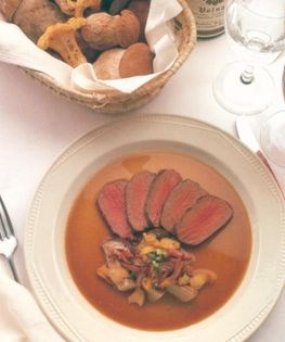 Sliced loin of roe deer with wood mushrooms, bacon and spring onions