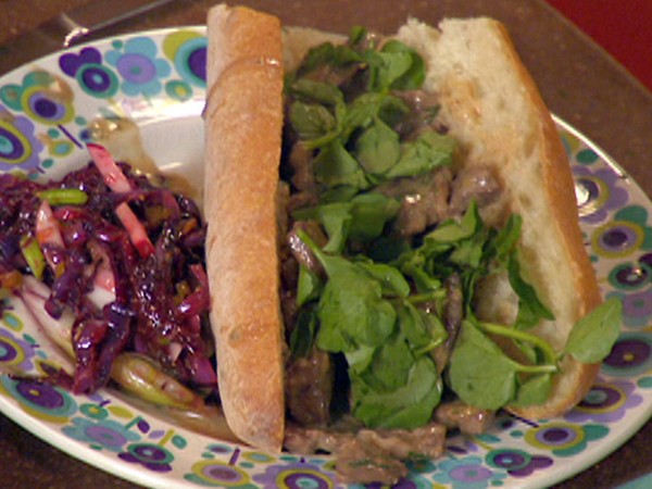 Sliced steak Sroganoff in French bread and dill relish dressed salad