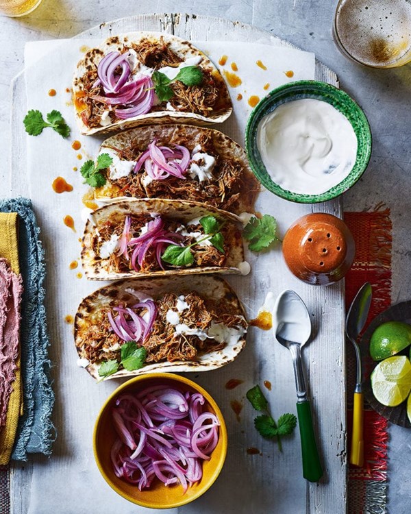 Slow-cooked chicken tinga tacos with pink pickled onions 