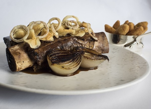 Slow-cooked Irish Jacob's ladder, Jerusalem artichoke chips, Roscoff onions