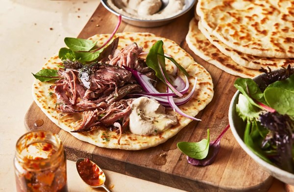 Slow-cooked lamb with tahini sauce & yogurt flatbread