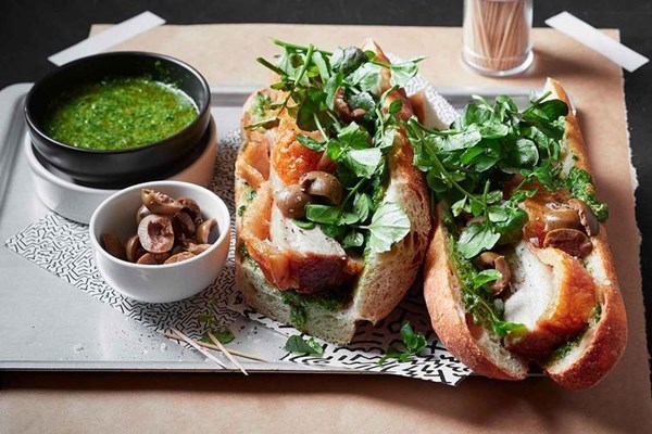 Slow-cooked pork baguettes with olives and salsa verde