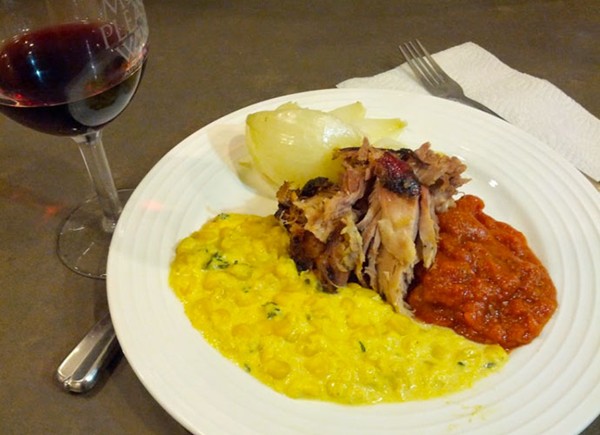 Slow-cooked pork shoulder with tomato gravy, creamed corn, and roasted baby Vidalias