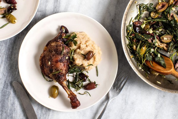 Slow-roasted duck with mashed white beans, sizzled herbs and olives