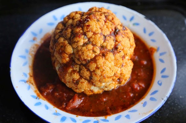 Slow roasted head of cauliflower in tomato chipotle sauce 
