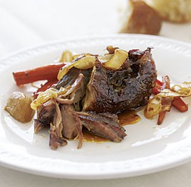 Slow-roasted pork shoulder with carrots, onions, and garlic