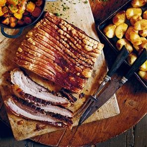 Slow-roasted pork with butter-roasted apples, lemony carrots and cider gravy