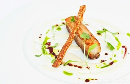 Slowly braised belly of pork with apple soup, garlic purée and Port jus