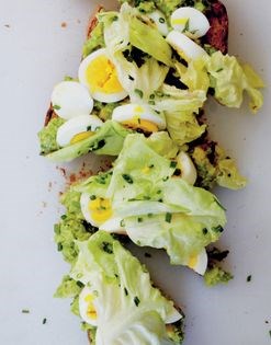 Smashed avocado toast with hard-boiled eggs and anchovy dressing