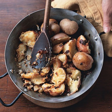 Smashed baby red potatoes with ancho chiles and dry Jack cheese