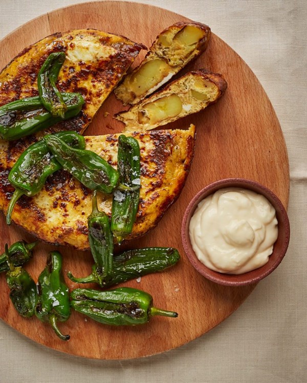 Smashed Jersey Royal tortilla with aioli and Padrón peppers