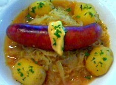 Smoked chicken apple sausage with cider-braised cabbage and new potatoes