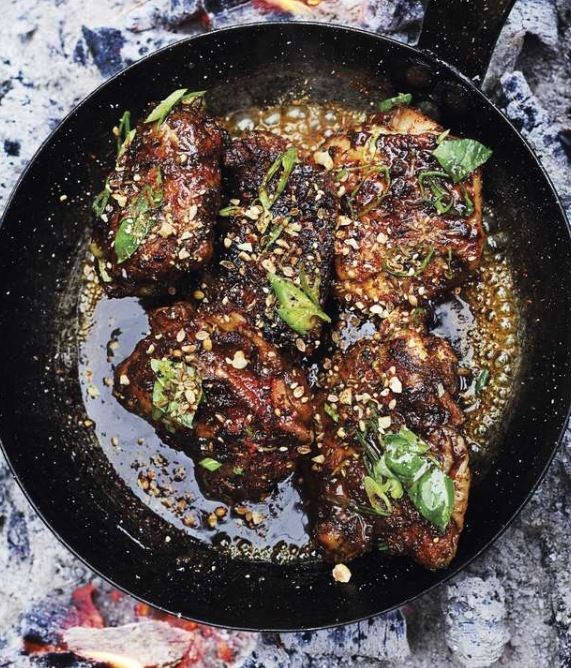 Smoked chicken thighs with saffron & orange blossom caramel, hazelnut dukkah & basil