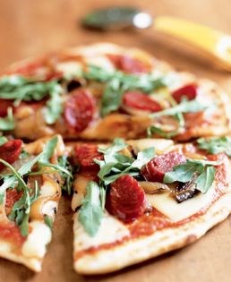 Smoked chorizo pizza with caramelized onions and arugula