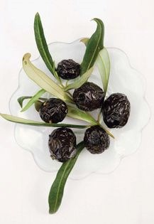 Smoked olives and garlic cloves in olive oil