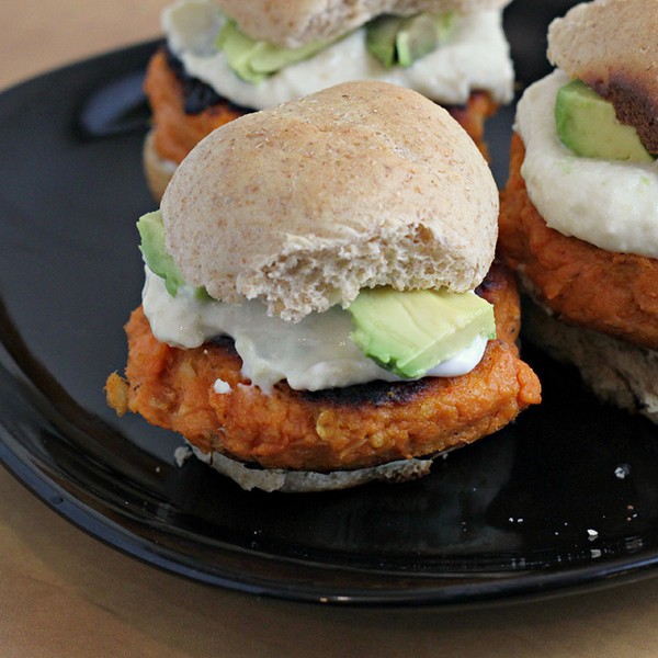 Smoky sweet potato burgers with roasted garlic cream and avocado on whole wheat sliders