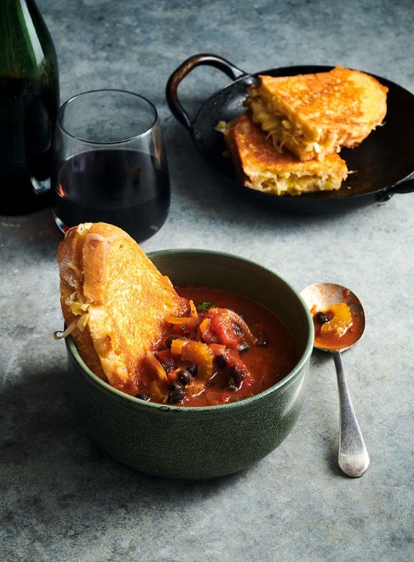 Smoky tomato and black bean soup with aged cheddar and sauerkraut toasties