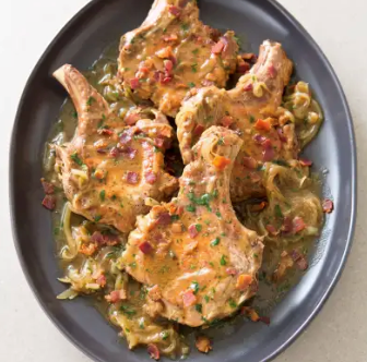 Smothered pork chops with onions and bacon