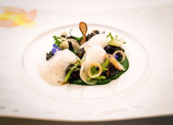 Snails served on a coulis of watercress with garlic crisps