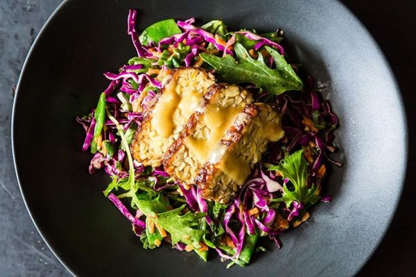 Snow pea, cabbage, and mizuna salad with marinated and seared tempeh